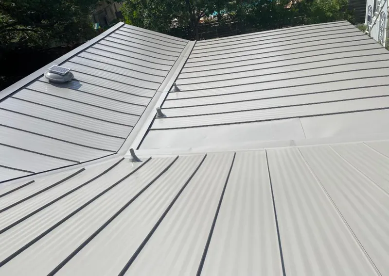 Solar attic fan installed on a metal roof for Roof Ventilation in Waldwick